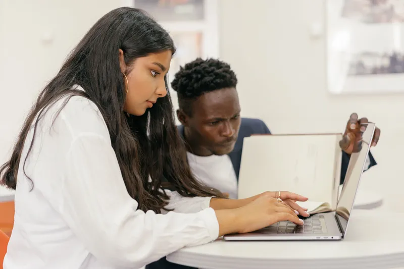 Students collaborating on a laptop